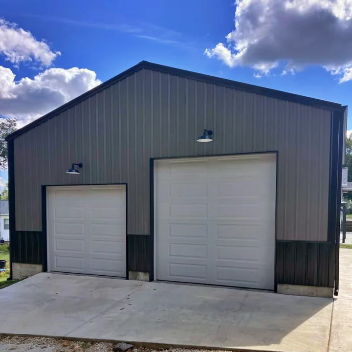 image placeholder A metal building with two white garage doors and exterior lights—perfect for West County residents seeking quality garage door solutions.